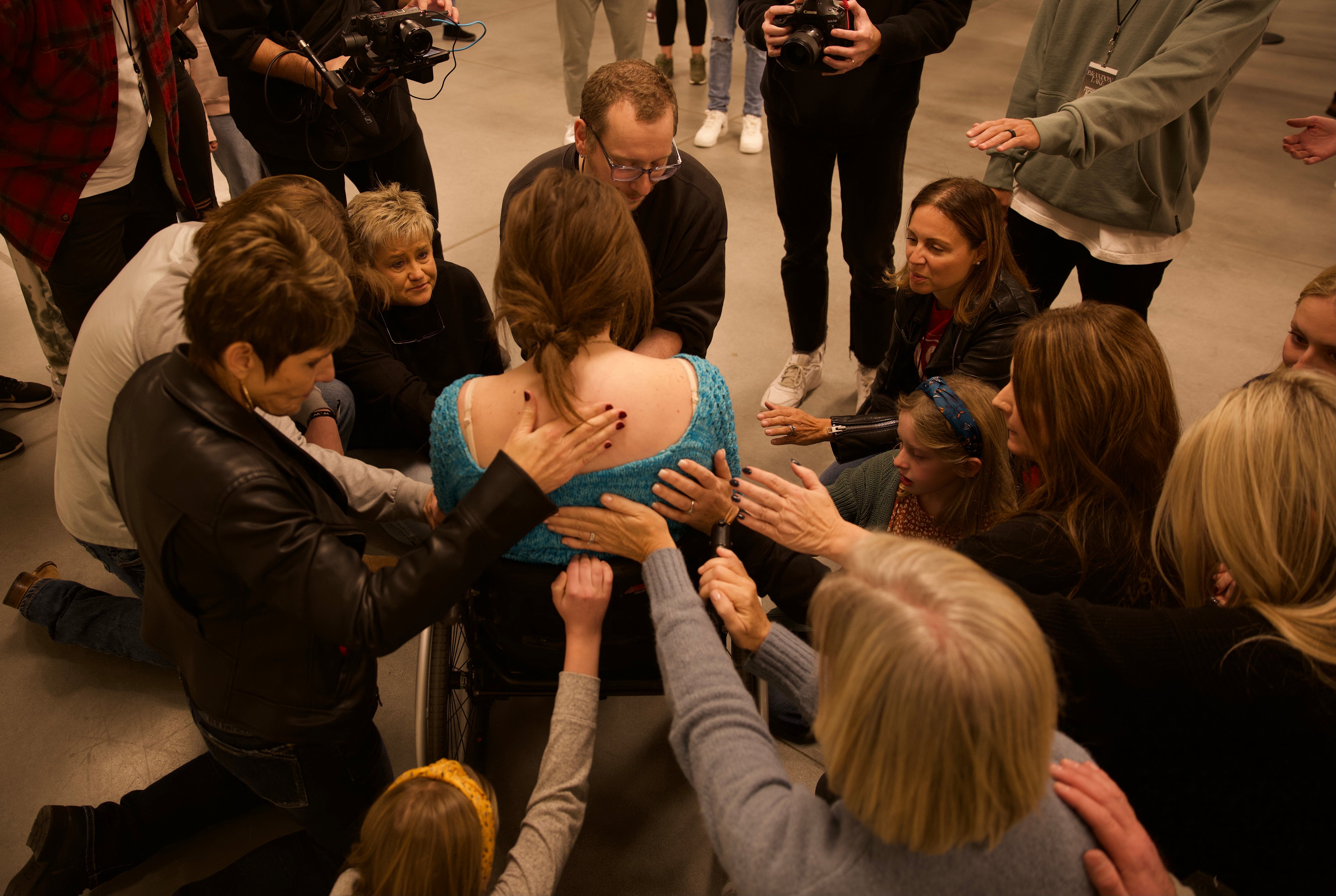 A young woman being prayed for during ministry